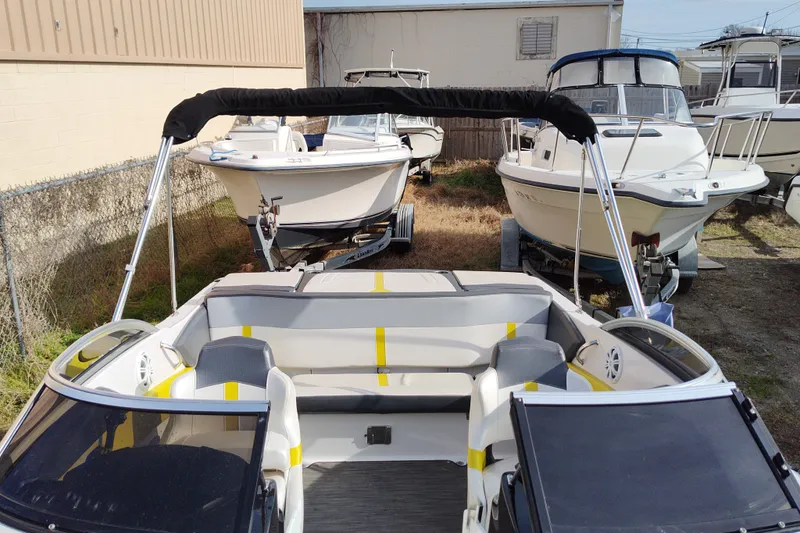 Slide: The Image of 2017 Four Winns 200 Horizon LE boat with seating, parked among other boats. - 2