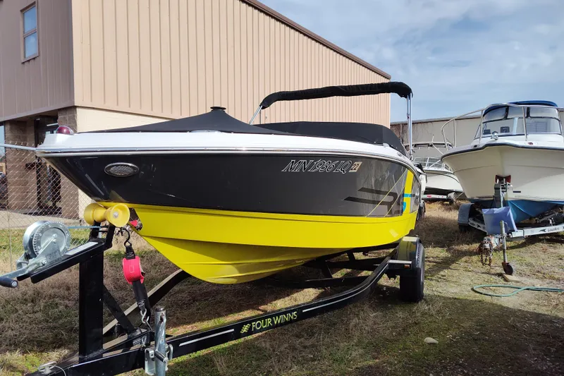 Slide: The Image of 2017 Four Winns 200 Horizon LE boat on trailer, black and yellow design. - 3