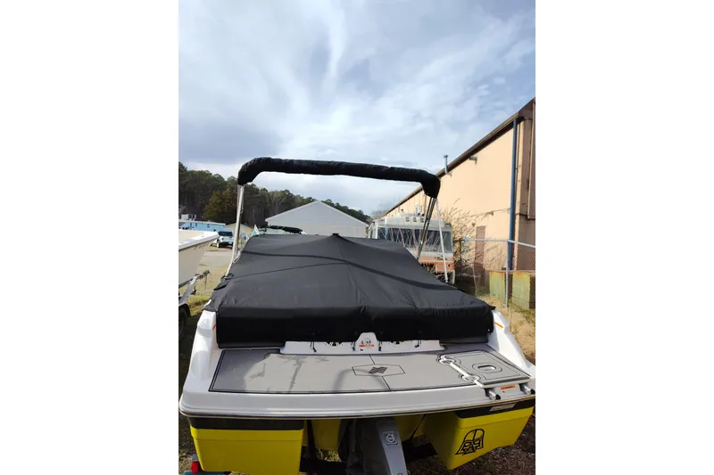 Slide: The Image of 2017 Four Winns 200 Horizon LE boat with black cover and bimini top. - 7