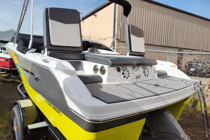 Slide: The Image of 2017 Four Winns 200 Horizon LE boat with vibrant yellow and black design on trailer. - 8