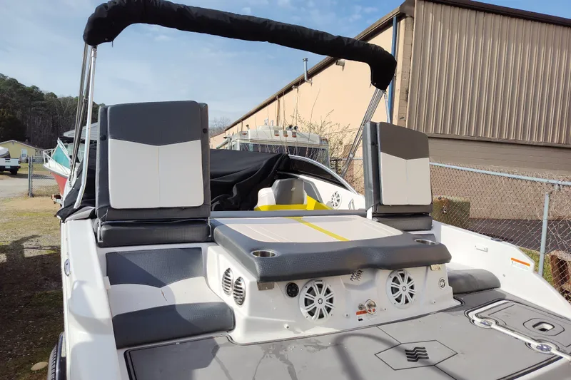 Slide: The Image of 2017 Four Winns 200 Horizon LE boat with seating and speakers, docked outdoors. - 9