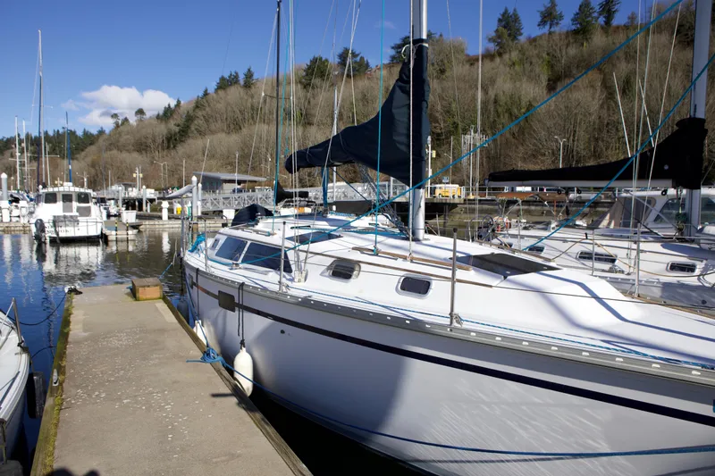 Slide: The Image of 1992 Hunter 33.5 sailboat docked at a marina on a sunny day. - 1