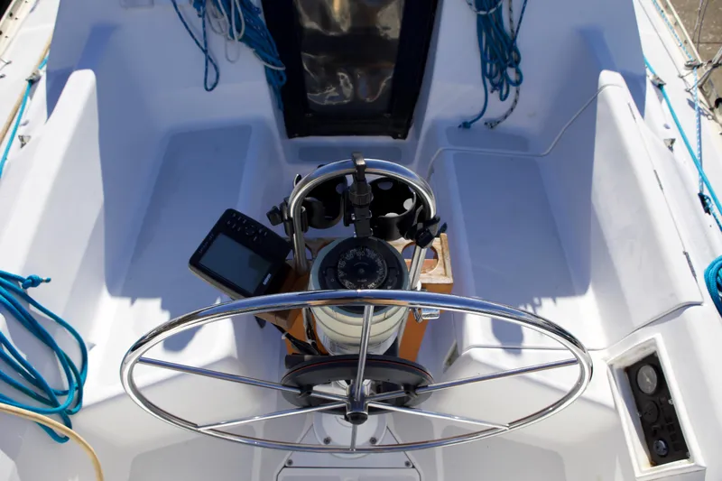 Slide: The Image of Cockpit of 1992 Hunter 33.5 sailboat with steering wheel and navigation equipment. - 10
