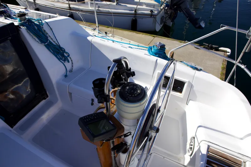 Slide: The Image of Cockpit of 1992 Hunter 33.5 sailboat with steering wheel and navigation instruments. - 11