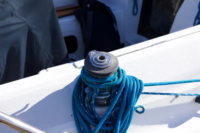 Slide: The Image of Blue rope coiled around a winch on a 1992 Hunter 33.5 sailboat deck. - 12