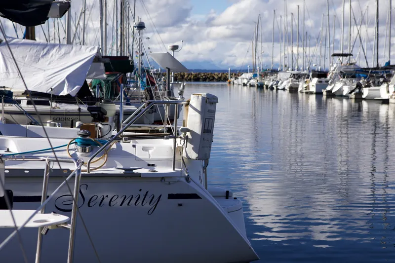 Slide: The Image of Hunter 33.5 sailboat "Serenity" docked in a marina, calm waters, 1992 model. - 14
