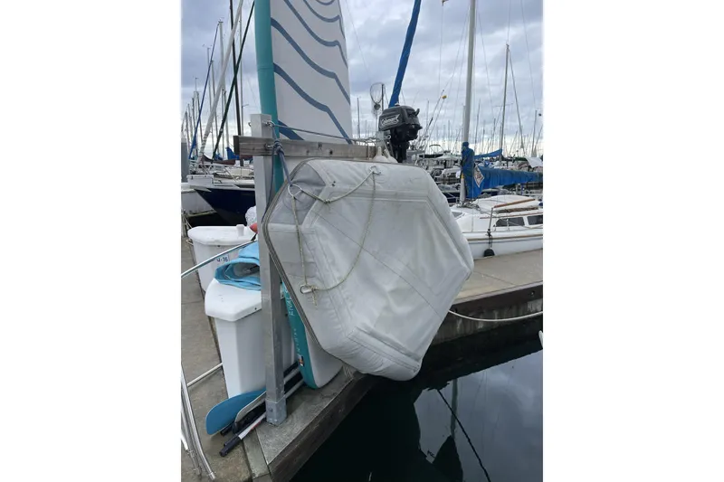 Slide: The Image of Docked 1992 Hunter 33.5 sailboat with covered sail and outboard motor. - 16