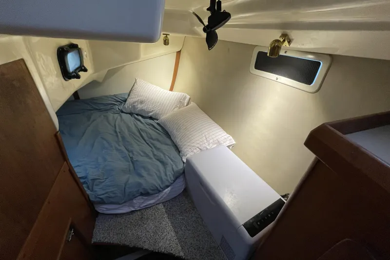 Slide: The Image of Cozy cabin interior of 1992 Hunter 33.5 sailboat with bed and porthole. - 17