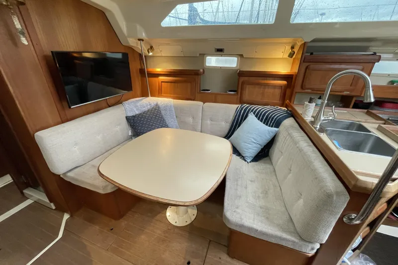 Slide: The Image of Cozy interior of 1992 Hunter 33.5 sailboat with dining area and kitchenette. - 19
