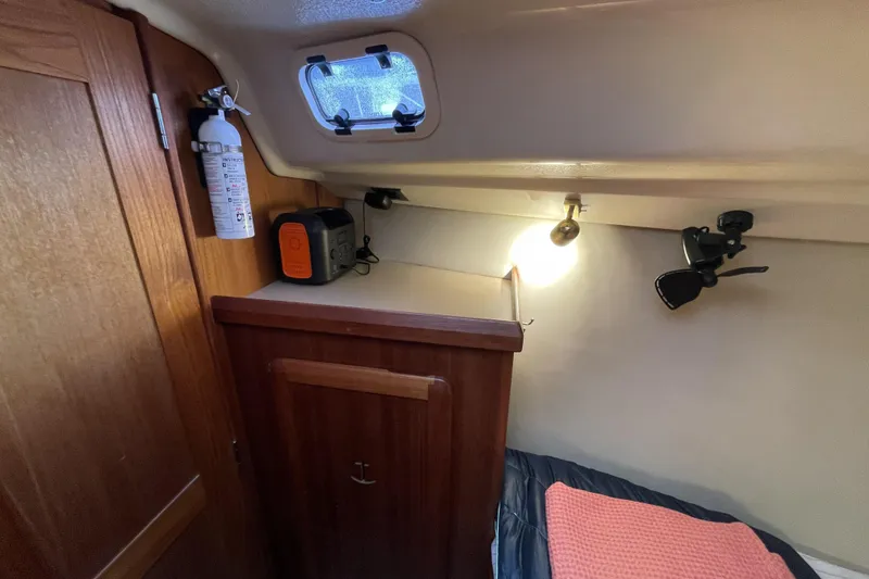 Slide: The Image of Cozy cabin interior of 1992 Hunter 33.5 sailboat with storage and lighting. - 24