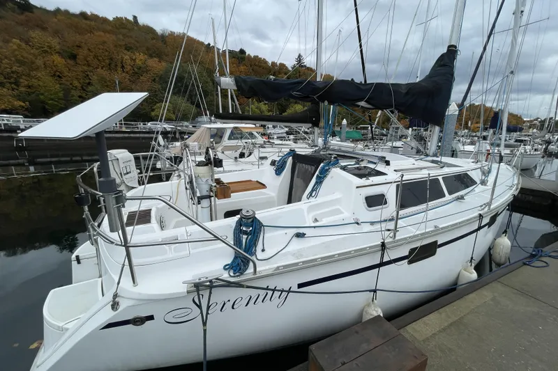 Slide: The Image of Hunter 33.5 sailboat from 1992 named "Serenity" docked at a marina. - 4