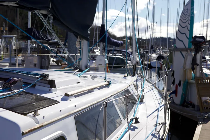 Slide: The Image of Hunter 33.5 sailboat from 1992 docked at a marina, surrounded by other boats. - 7