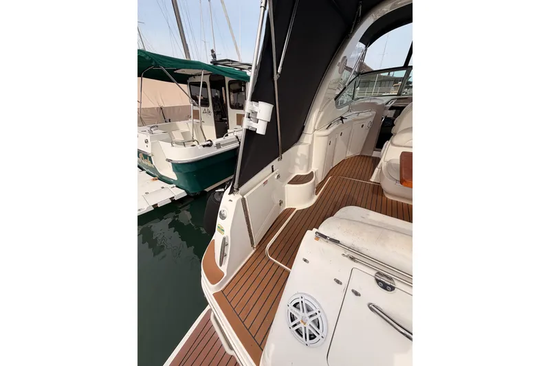 Slide: The Image of 2005 Sea Ray 300 Sundancer boat with teak deck, docked at marina. - 10
