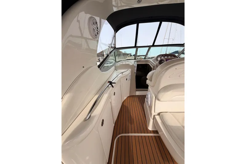 Slide: The Image of 2005 Sea Ray 300 Sundancer interior with sleek design and wooden flooring. - 13