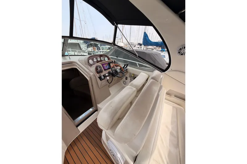 Slide: The Image of 2005 Sea Ray 300 Sundancer helm with modern controls and comfortable seating. - 15