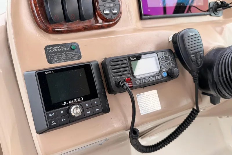 Slide: The Image of Control panel of a 2005 Sea Ray 300 Sundancer with audio and communication systems. - 18