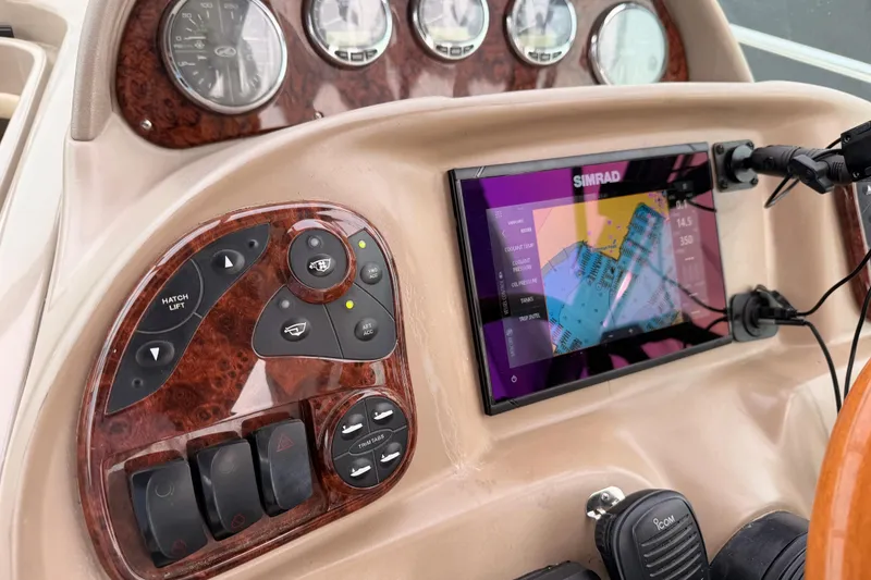 Slide: The Image of Dashboard of 2005 Sea Ray 300 Sundancer with Simrad navigation display and control panel. - 19