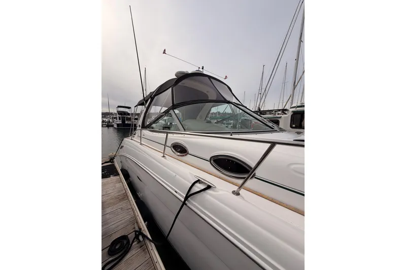 Slide: The Image of 2005 Sea Ray 300 Sundancer docked at marina, showcasing sleek design and modern features. - 3