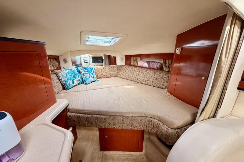 Slide: The Image of Interior cabin of 2005 Sea Ray 300 Sundancer with cozy bed and decorative pillows. - 33