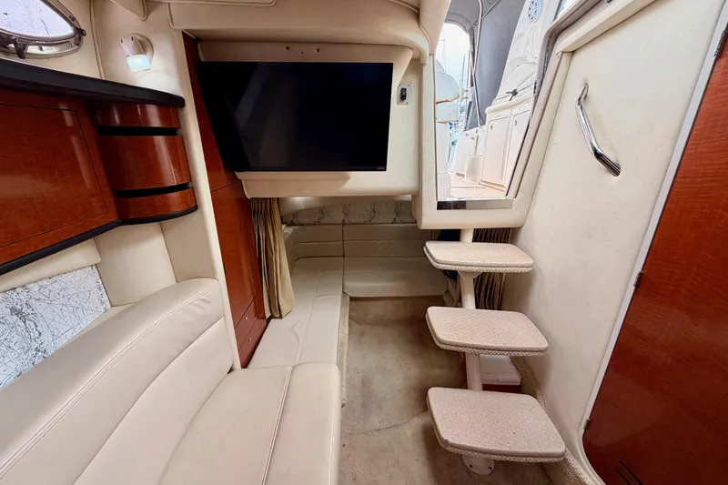 Slide: The Image of Interior of 2005 Sea Ray 300 Sundancer with TV, seating, and stairs. - 38