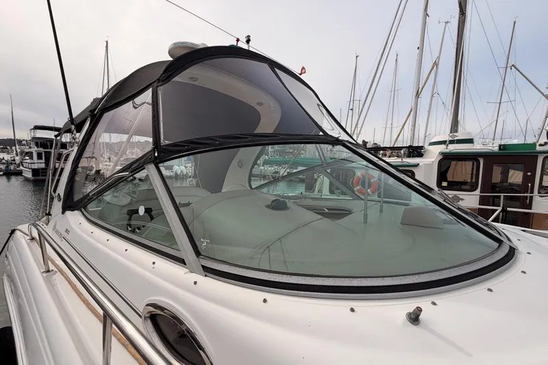 Slide: The Image of 2005 Sea Ray 300 Sundancer yacht docked at marina, featuring sleek design and spacious cockpit. - 4