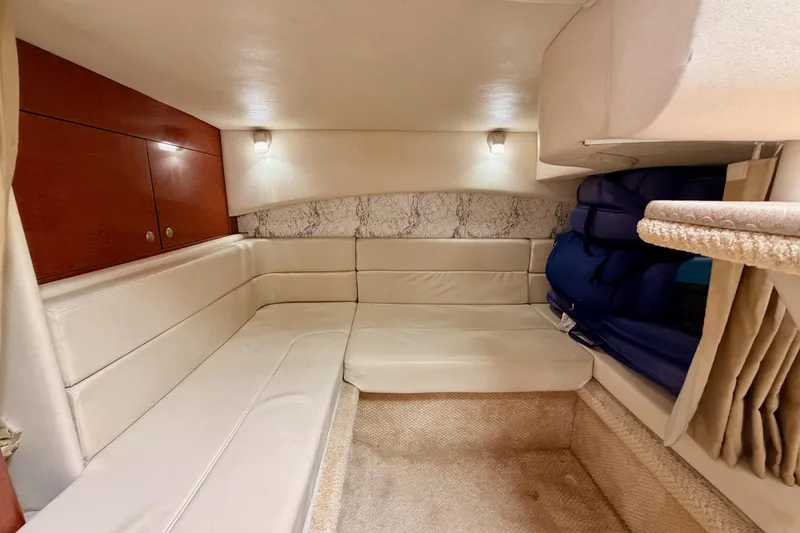 Slide: The Image of 2005 Sea Ray 300 Sundancer cabin interior with beige seating and wooden cabinets. - 41