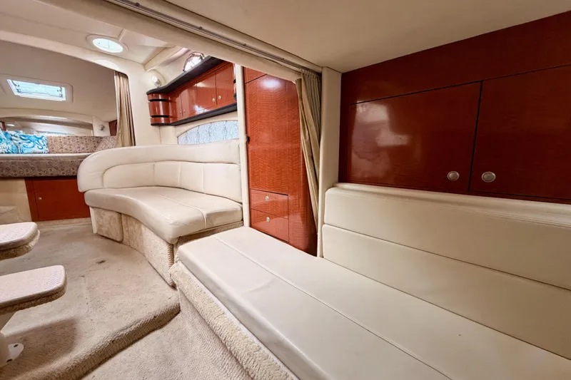 Slide: The Image of Interior of 2005 Sea Ray 300 Sundancer with plush seating and wood cabinetry. - 42