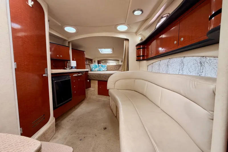 Slide: The Image of Luxurious interior of 2005 Sea Ray 300 Sundancer yacht with elegant seating and cabinetry. - 43