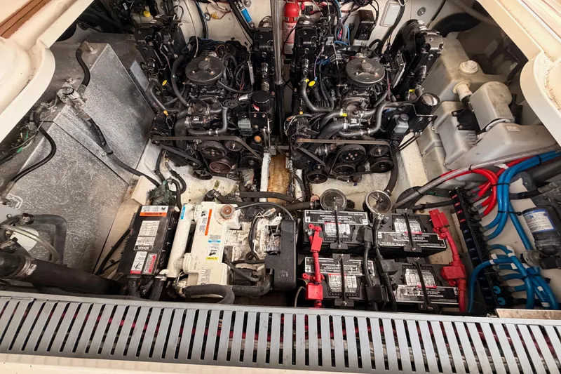 Slide: The Image of Engine compartment of a 2005 Sea Ray 300 Sundancer with visible batteries and wiring. - 44