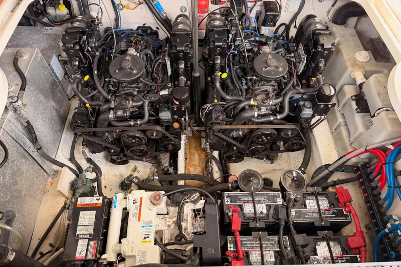 Slide: The Image of Engine compartment of a 2005 Sea Ray 300 Sundancer with dual engines and batteries. - 49