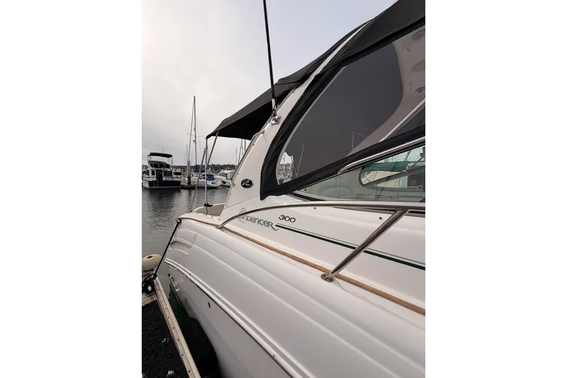 Slide: The Image of 2005 Sea Ray 300 Sundancer docked at marina, side view. - 5