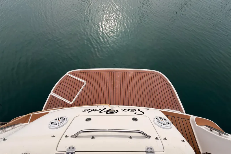 Slide: The Image of 2005 Sea Ray 300 Sundancer boat deck overlooking calm water. - 7
