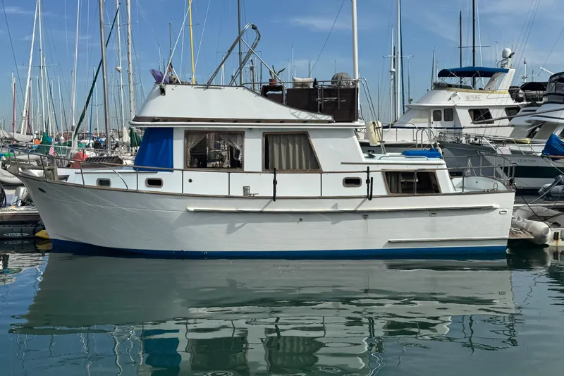 The Image of 1978 CHB 35 boat docked in a marina, surrounded by other vessels. - 1