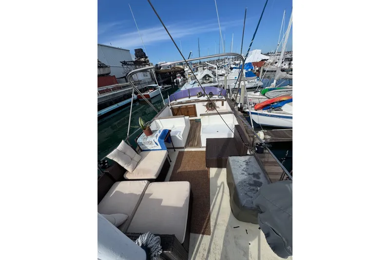 Slide: The Image of 1978 CHB 35 boat with outdoor seating, docked at a marina under clear blue skies. - 11