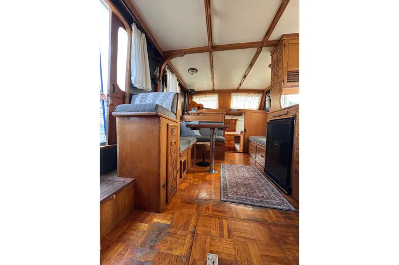 Slide: The Image of Interior of a 1978 CHB 35 boat with wooden furnishings and cozy seating. - 14
