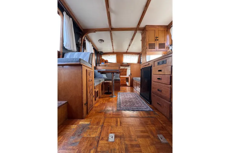 Slide: The Image of Interior of a 1978 CHB 35 boat with wooden furnishings and cozy seating area. - 16