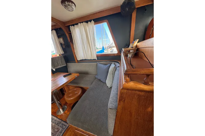 Slide: The Image of Cozy interior of 1978 CHB 35 boat with wooden accents and seating area. - 18