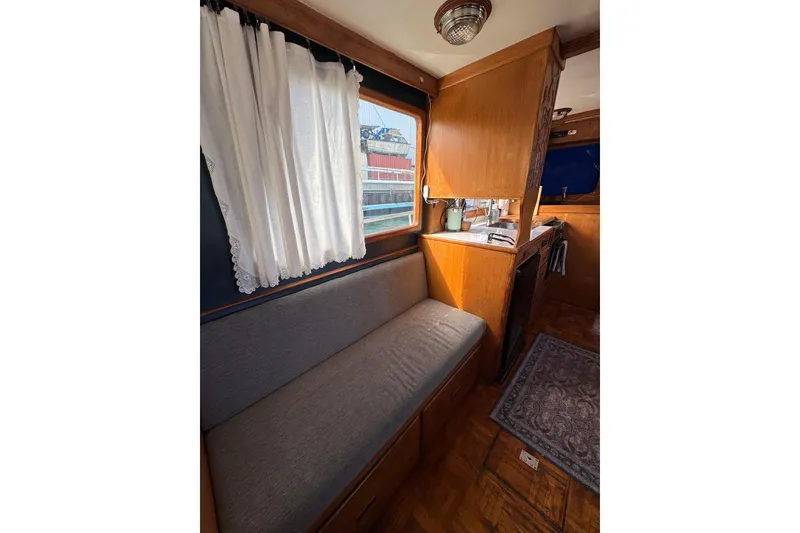 Slide: The Image of Interior of a 1978 CHB 35 boat with cozy seating and wooden cabinetry. - 20