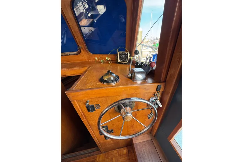 Slide: The Image of 1978 CHB 35 boat helm with wooden dashboard and steering wheel. - 23
