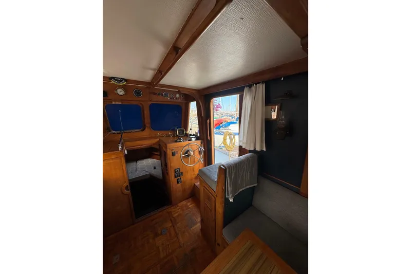 Slide: The Image of Interior of a 1978 CHB 35 boat with wooden helm and seating area. - 24