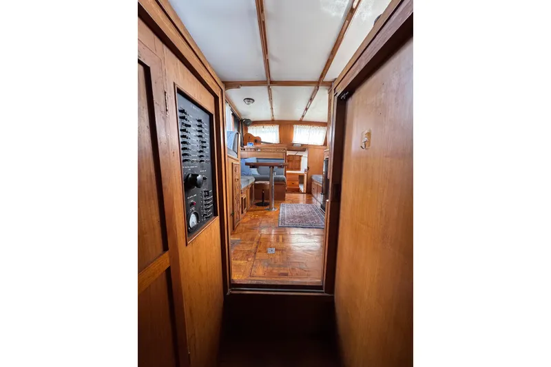 Slide: The Image of Interior of 1978 CHB 35 boat, featuring wooden paneling and cozy seating area. - 25