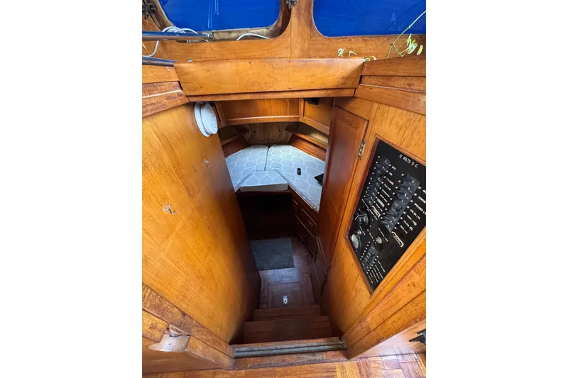 Slide: The Image of Interior view of 1978 CHB 35 boat, featuring wooden cabinetry and control panel. - 26