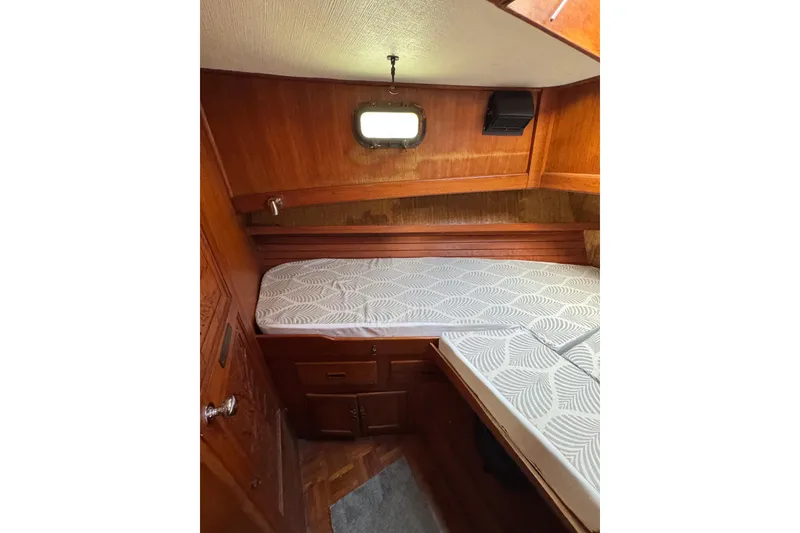 Slide: The Image of 1978 CHB 35 boat cabin with wooden interior and patterned mattress. - 29