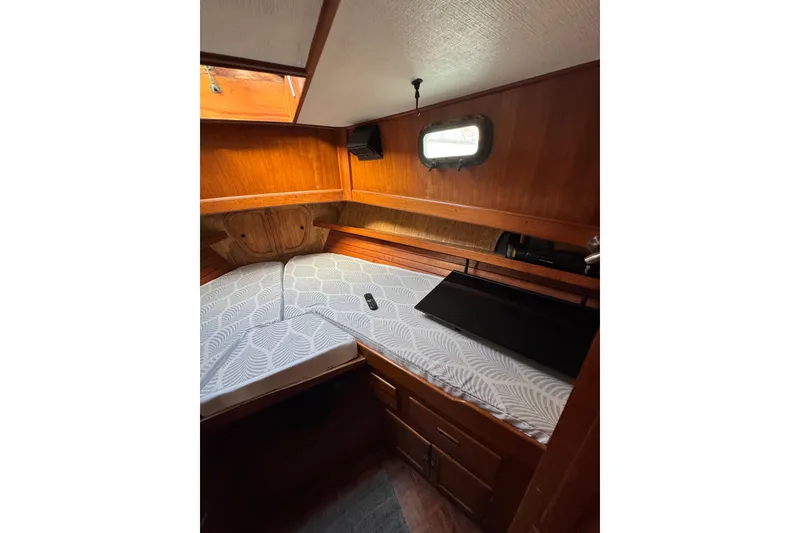 Slide: The Image of Cozy cabin interior of 1978 CHB 35 boat with wooden paneling and bed. - 30