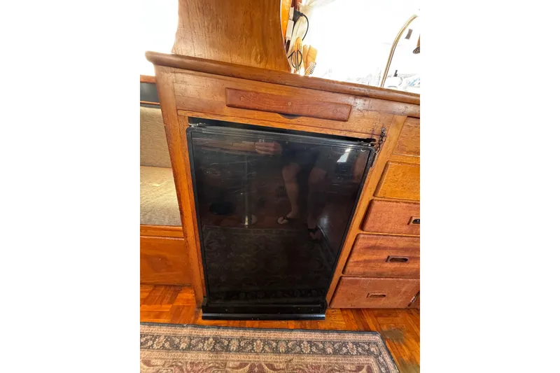 Slide: The Image of Wooden cabinetry with a black glass door on a 1978 CHB 35 boat interior. - 32