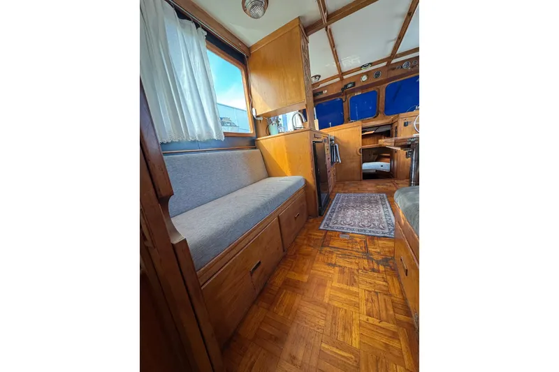 Slide: The Image of 1978 CHB 35 boat interior with wooden furnishings and cozy seating area. - 33