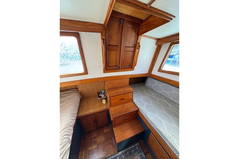 Slide: The Image of 1978 CHB 35 boat interior with wooden cabinetry and cozy sleeping area. - 36