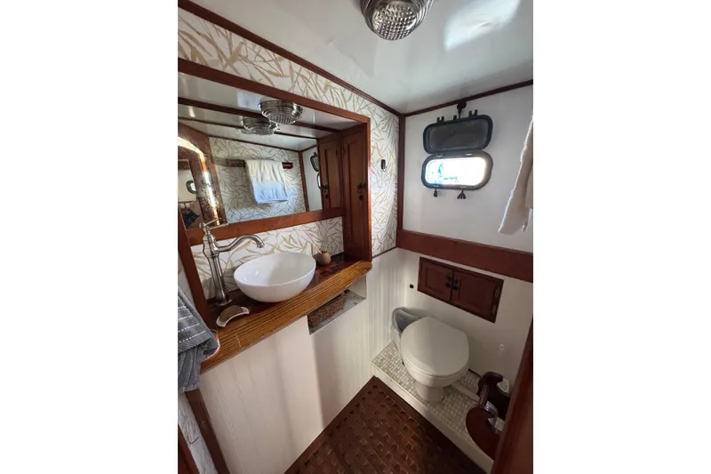 Slide: The Image of Vintage 1978 CHB 35 boat bathroom with wooden accents and modern sink. - 39