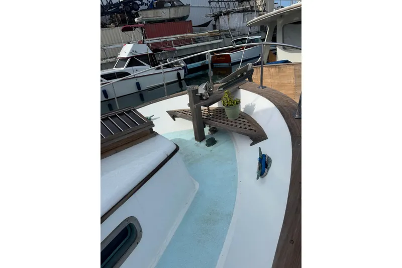 Slide: The Image of 1978 CHB 35 boat deck with anchor and potted plant, docked at marina. - 4