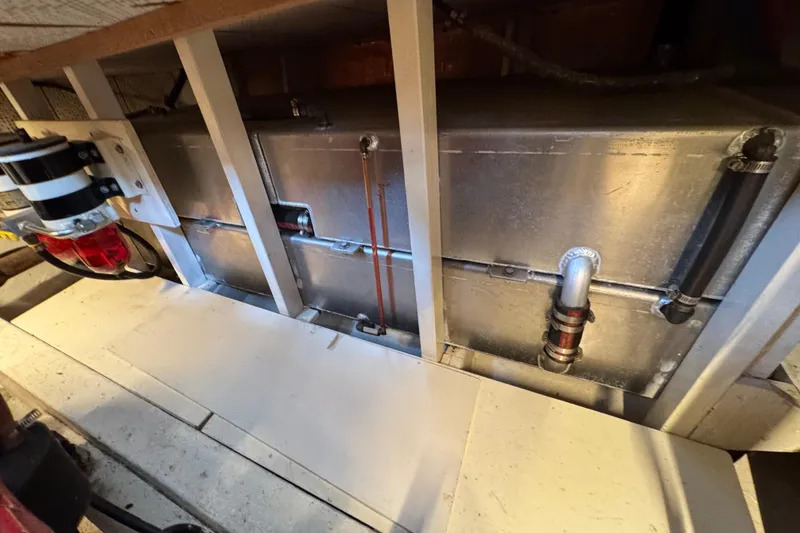Slide: The Image of 1978 CHB 35 engine compartment with metal components and piping. - 40